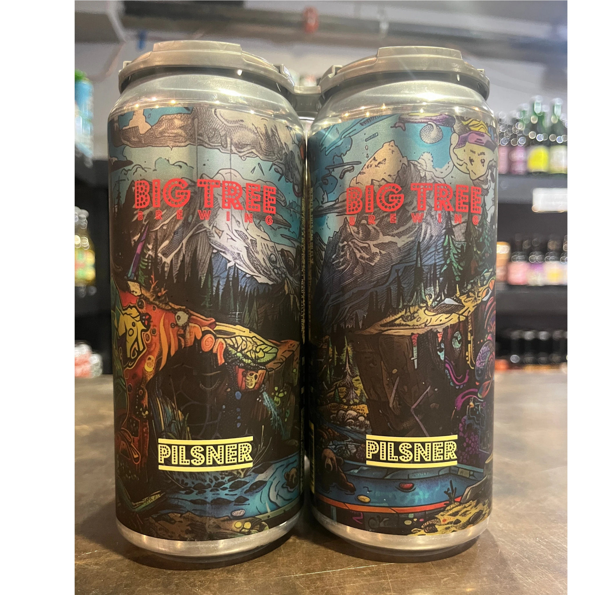 Stowe Public House & Bottle Shop Big Tree Pilsner beer cans with colorful, surreal mountain and nature artwork.