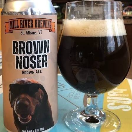 Stowe Public House & Bottle Shop Mill River Brown Noser brown ale in a glass next to its branded beer can