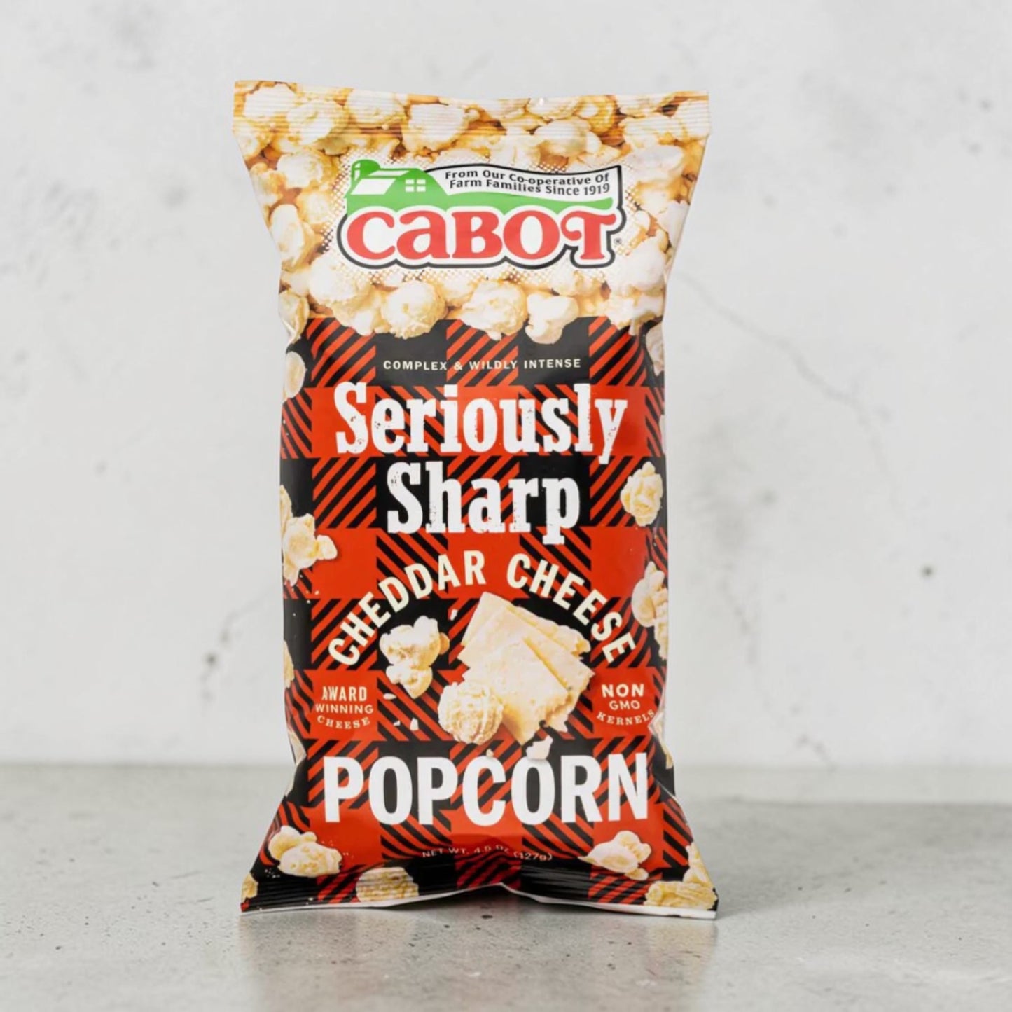 Stowe Public House & Bottle Shop Cabot Seriously Sharp Cheddar Cheese Popcorn bag with red and black buffalo plaid design.