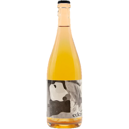 Stowe Public House & Bottle Shop Eden Ciders Benjamin Petillant Naturel cider, bright yellow, in a clear glass bottle with a black cap.