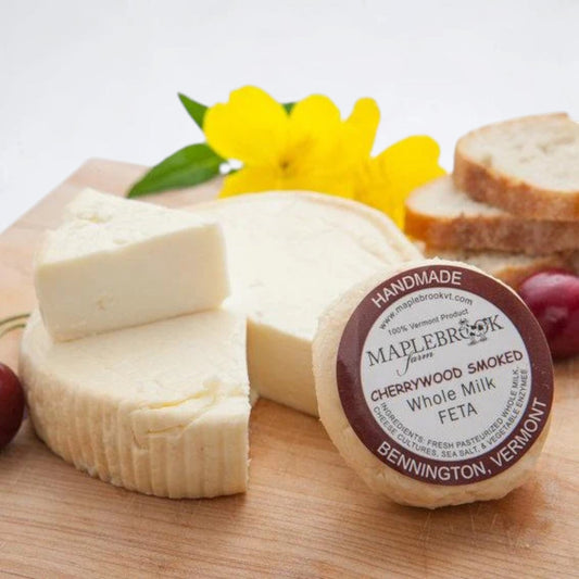 Stowe Public House & Bottle Shop Maplebrook Farm Cherrywood Smoked Feta cheese on a wooden board with cherries and bread.