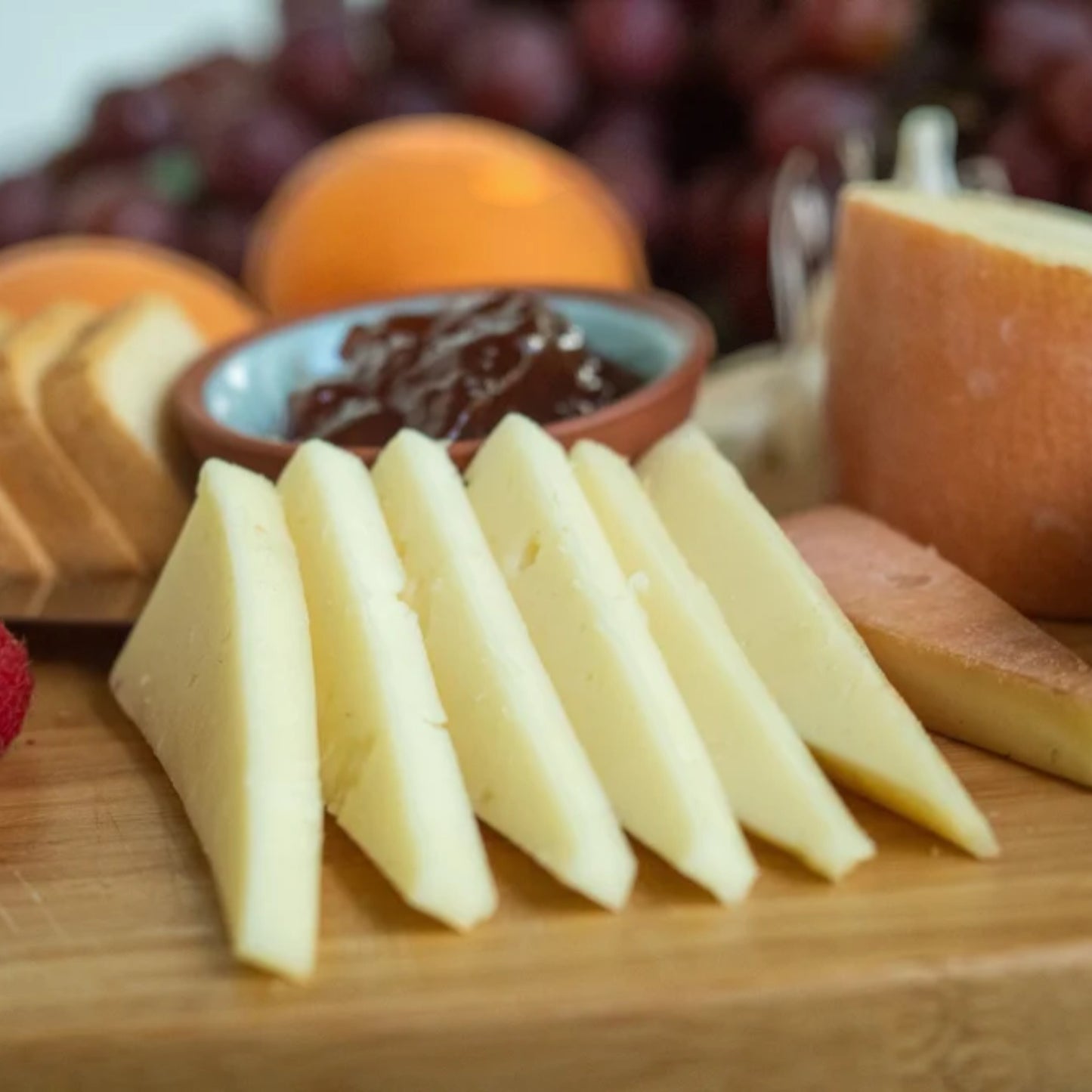 Stowe Public House & Bottle Shop's Southwind cheese, a mild farmer's cheese, served sliced with grapes, raspberries, jam, and nuts.