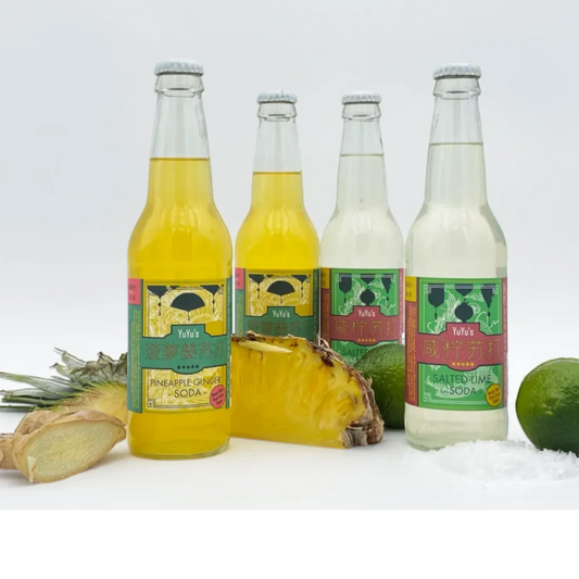 Stowe Public House & Bottle Shop YuYu's Pineapple Ginger Soda in glass bottles with pineapple, ginger, and limes.